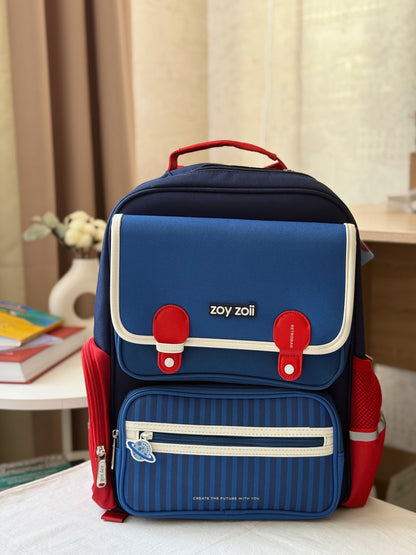Zoy Zoii mochila escolar azul con detalles rojos, diseño clásico con bolsillos frontales, cremallera resistente y correas acolchadas, ideal para niños en la escuela primaria