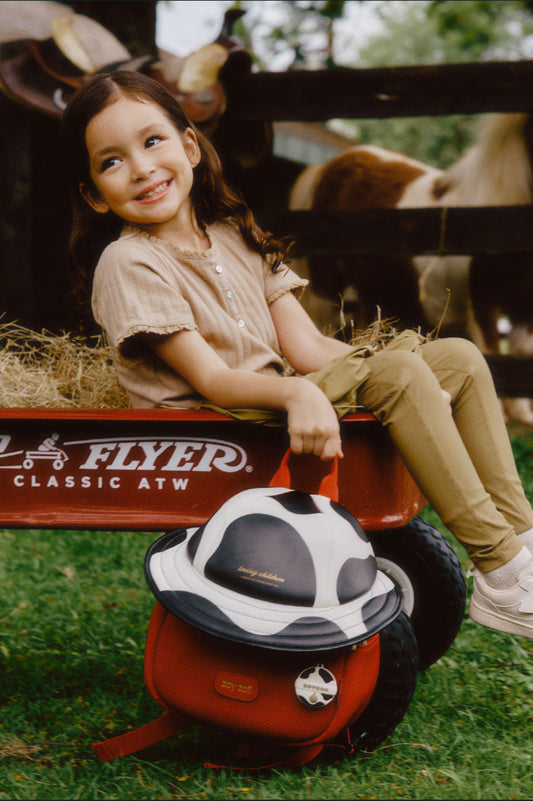 Mochila infantil Zoy Zoii en color rojo con estampado de vaquita.